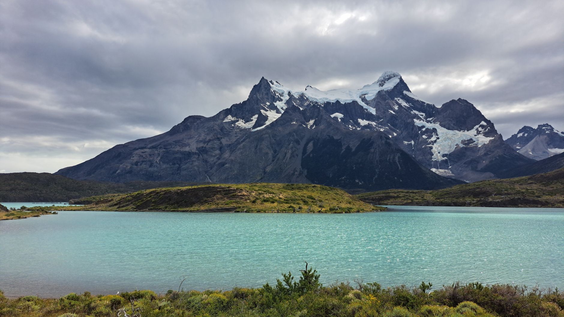 Towering Patagonian granite spires reflecting over glacial water